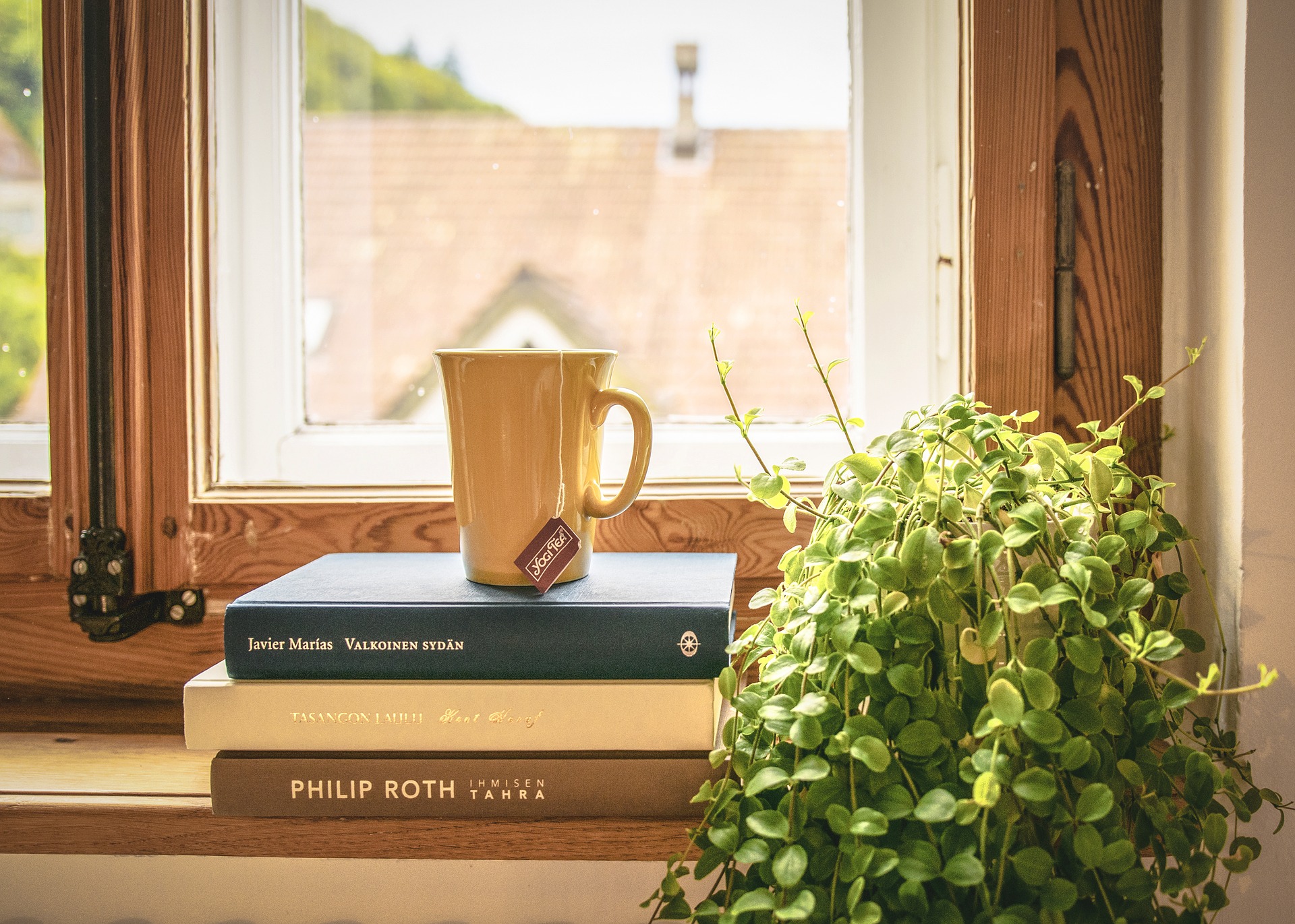 Coffee cup and three books
